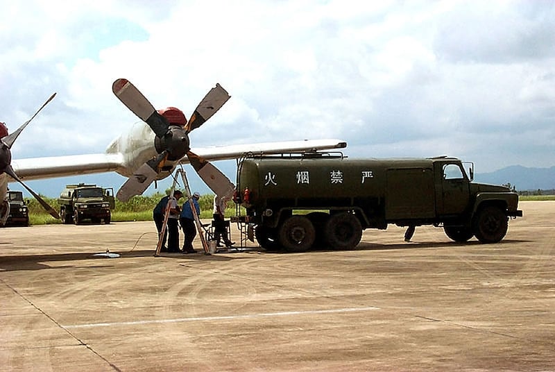 A U.S. team removes fuel and other fluids from an American EP-3E reconnaissance aircraft with a damaged propeller at Lingshui Airfield June 18, 2001 in Hainan, China.