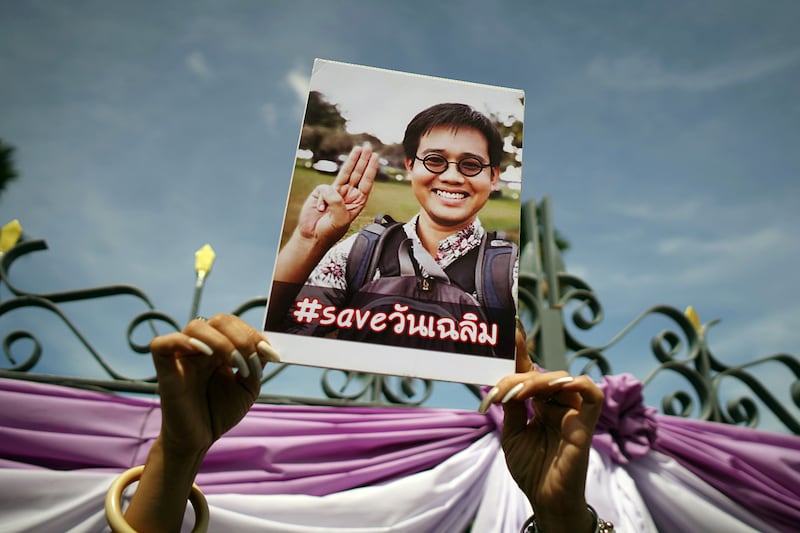 An activist holds up a picture of Thai activist Wanchalearm Satsaksit at a protest calling for an investigation, in Bangkok, June 12, 2020.