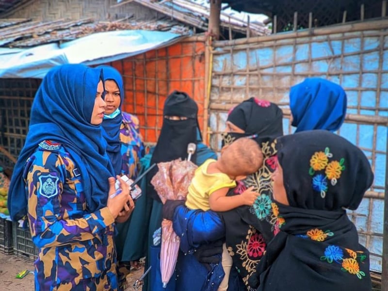 Female members of 8th Armed Police Battalion speak with Rohingya women at the Kutupalong-Balukhali mega camp area in Ukhia, Cox's Bazar, Bangladesh, July 3, 2022. Credit: BenarNews