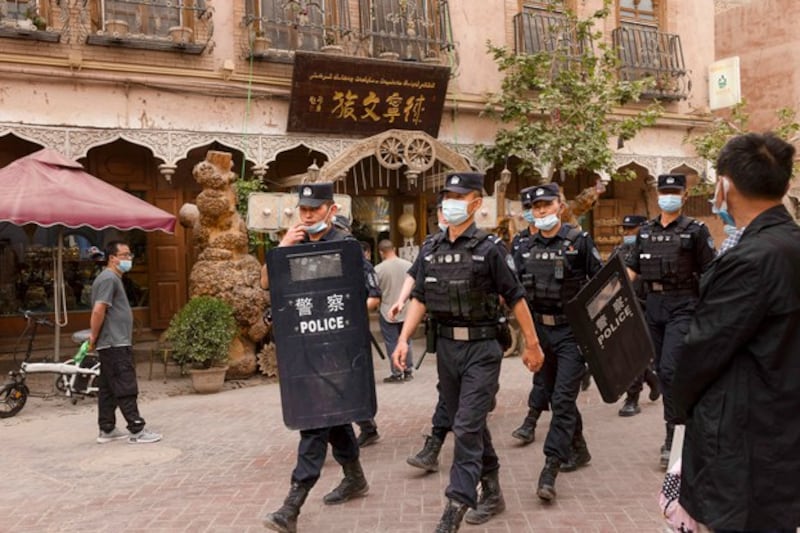 Police officers patrol Kashgar Old City in northwestern China's Xinjiang Uyghur Autonomous Region, May 4, 2021. (Thomas Peter/Reuters)