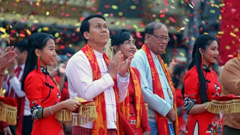 Yangon region Chief Minister Phyo Min Thein (2nd from L) claps during a celebration marking the Lunar New Year along with his wife (C) at Chinatown in Yangon, Jan. 25, 2020.