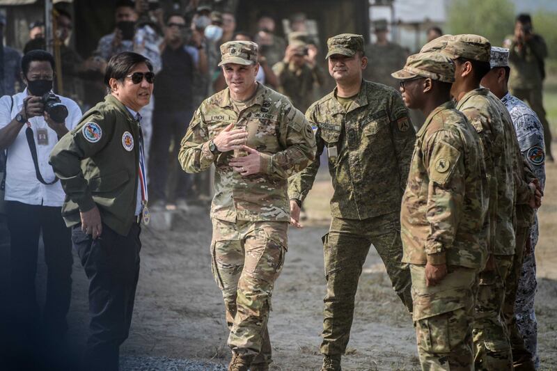 Philippine President Ferdinand Marcos Jr. is briefed by American and Philippine soldiers about a multiple rocket launcher during joint exercises in San Antonio town, Zambales, northern Philippines, April 26, 2023. [Jojo Riñoza/BenarNews]