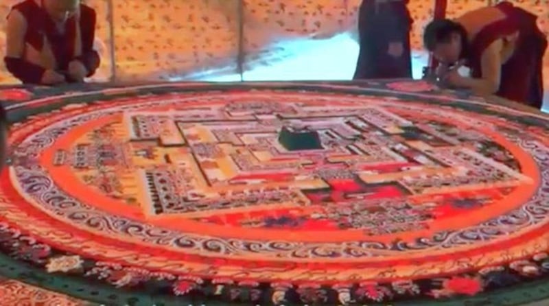 Tibetan Buddhist monks stand near a sand mandala created for a Kalachakra teaching in Hainan Tibetan Autonomous Prefecture, northwestern China's Qinghai province, July 2023. Credit: RFA listener