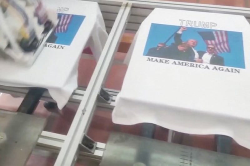 A T-shirt printing machine prints images of former US President Donald Trump's following an assassination attempt, in Jieyang, Guangdong province, China, July 15, 2024. (Reuters/Paxinico)