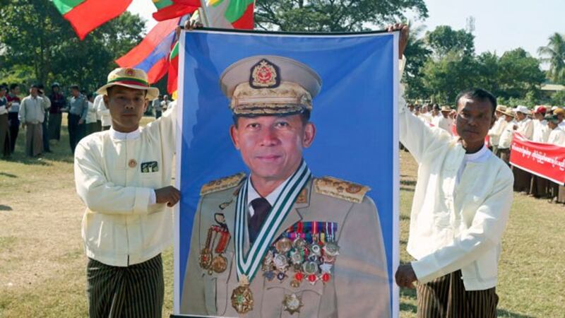 Myanmar demonstrators hold a portrait of military chief Senior General Min Aung Hlaing during a rally to support Myanmar's military in Naypyidaw, Jan. 23, 2019. 