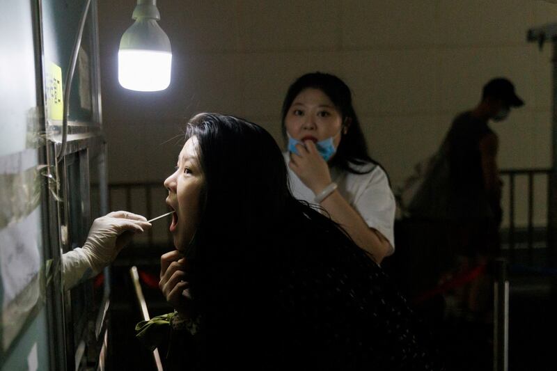 A woman gets a swab test at a nucleic acid testing station, following a COVID-19 outbreak in Beijing, July 14, 2022. Credit: Reuters