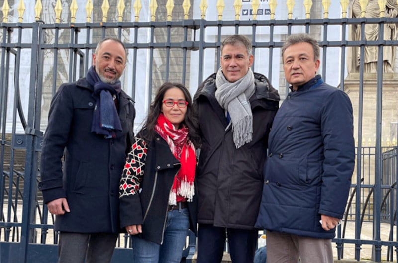 Dilnur Reyhan (2nd from L), president of the Uyghur European Institute, and Dolkun Isa (R), president of the World Uyghur Congress, stand with two French lawmakers outside parliament following the passage of a resolution labeling China's persecution of its Uyghur minority a genocide, in Paris, Jan. 20, 2022. Credit: RFA