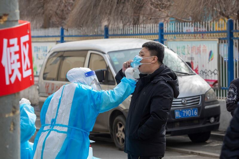 A resident undergoes a nucleic acid test for the Covid-19 coronavirus in Jilin in China's northeastern Jilin province, March 9, 2022. Credit: AFP