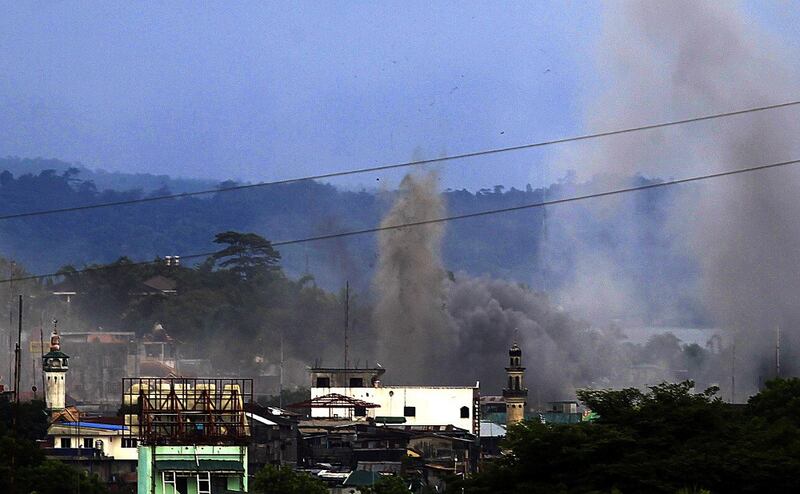 Bombs scatter dust, black smoke and debris in the southern Philippine city of Marawi as government planes bombard Muslim militant positions, June 1, 2017. Credit: Mark Navales/BenarNews