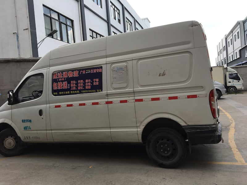 A van waits in the Guangzhou garment district to carry partly finished clothes inland for final work in this undated photo.