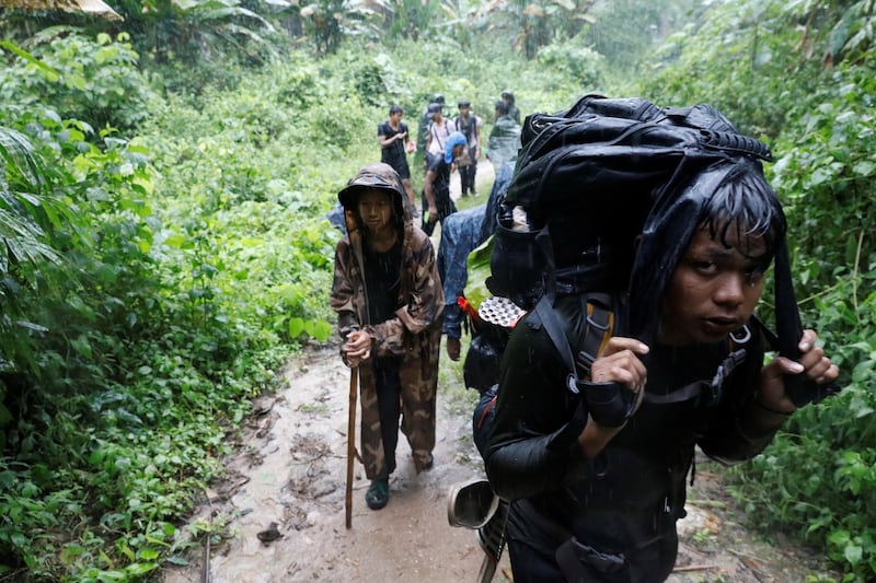 Members of the People's Defence Force (PDF) hike at a training camp in an area controlled by ethnic Karen rebels, Karen State, Myanmar, Sept. 2021. Credit: Reuters