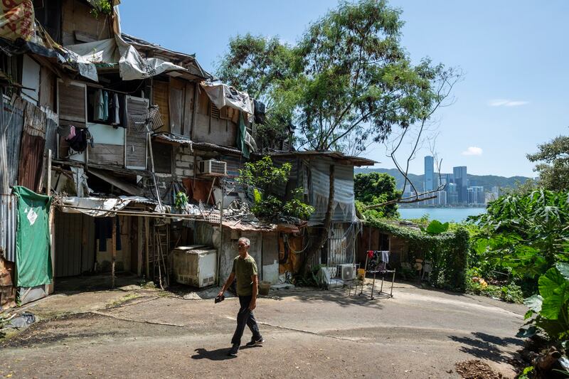 A villager walks past a squatter settlement in Hong Kong, Aug. 25, 2024. (Chan Long Hei/AP)