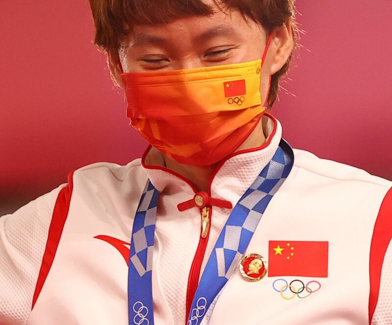 Gold medalist Zhong Tianshi wears a badge of the late Chinese chairman Mao Zedong on the medal ceremony at the Tokyo Olympics, in Shizuoka, Japan, Aug. 2, 2021. Credit: Reuters