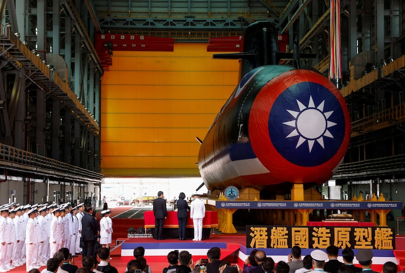 A bottle is broken against the hull of Narwhal, Taiwan's first domestically built submarine in Kaohsiung, Taiwan, Sept. 28, 2023.