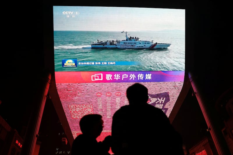 A giant screen shows news footage of military drills conducted in the Taiwan Strait and areas to the north, south and east of Taiwan, by the Eastern Theatre Command of the Chinese People's Liberation Army (PLA), in Beijing, China October 14, 2024. REUTERS/Tingshu Wang