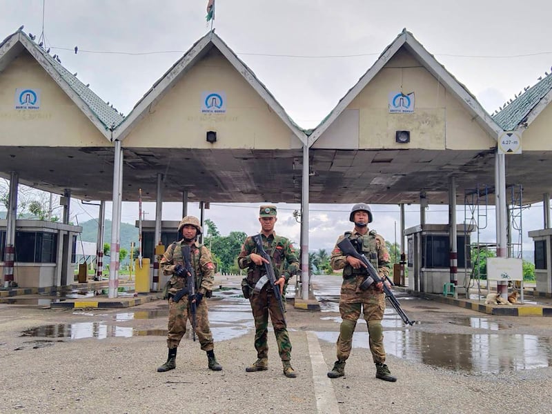 Members of the Ta'ang National Liberation Army and the Mandalay People's Defense Force stand in front of the captured toll gate in Nawnghkio township in Shan state, Myanmar, June 26, 2024. (Mandalay People's Defense Force via AP)