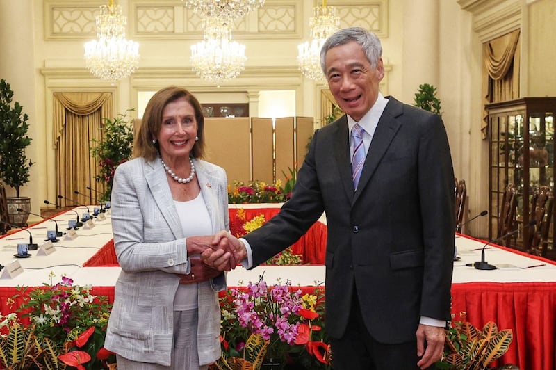 Singapore's Prime Minister Lee Hsien Loong (R) shakes hands with U.S. Speaker of the House Nancy Pelosi at the Istana Presidential Palace in Singapore during a visit to the Asia-Pacific region, Aug. 1, 2022. Credit: Singapore's Ministry of Communications and Information / AFP