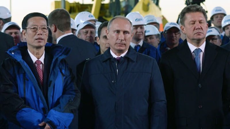 Chinese Vice Premier Zhang Gaoli (L), Russian President Vladimir Putin (C), and Gazprom CEO Alexei Miller (R) attend a ceremony marking the welding of the first link of the Power of Siberia main gas pipeline near the village of Us Khatyn outside the remote eastern Siberian city of Yakutsk, Russia, Sept. 1, 2014.