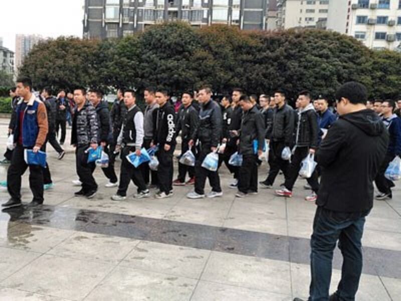 Chinese soccer 'fans,' who may be undercover police officers, carry identical goodie bags before a match between China and South Korea in Changsha, central China's Hunan province, March 22, 2017. 