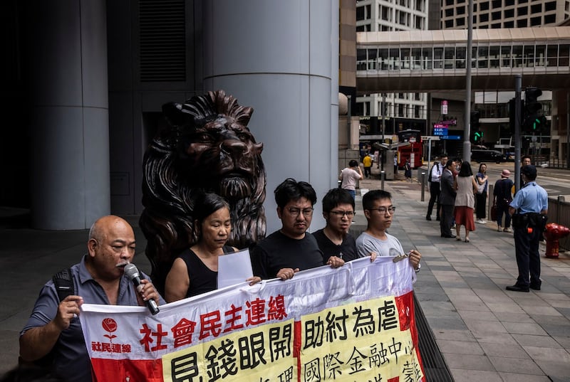 Veteran activist Tsang Kin-Shing [left], a member of the “League of Social Democrats,” speaks during a protest outside the headquarters of The Hong Kong and Shanghai Banking Corporation Limited (HSBC) in Hong Kong on Tuesday, June 6, 2023. Credit: AFP