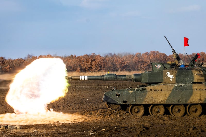 A Japan Ground Self-Defense Force Northern Army Type-90 tank participates in a live tank firing competition at the Hokkaido Great Maneuvering Ground in Eniwa, Hokkaido prefecture on Dec. 7, 2021. Credit: AFP