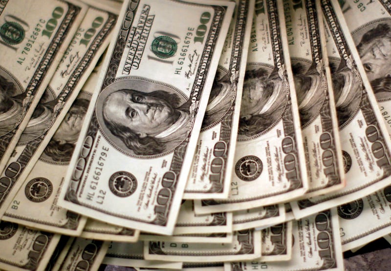 A pile of U.S. dollars counted out by a teller at a bank in Westminster, in the U.S. state of Colorado, Nov. 3, 2009.