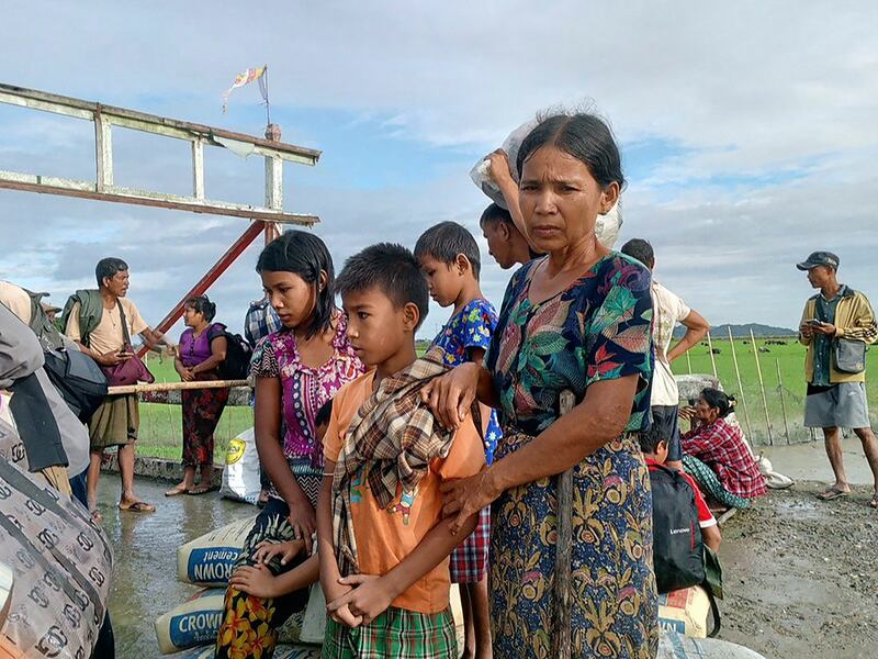 People flee from a village after renewed fighting between Myanmar's military and the Arakan Army Pauktaw Township, Rakhine State on Nov. 19, 2023.