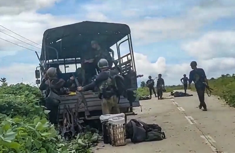 Arakan Army fighters remove weapons from a Myanmar army truck after a clash with junta troops in Rakhine state's Maungdaw township, July 18, 2022. Credit: Screengrab from Arakan Princess Media video