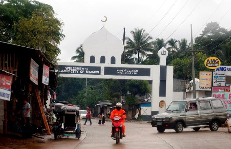 A motorcyclist passes an arch marking the limits of Marawi City in the southern Philippines, May 21, 2021. Credit: BenarNews