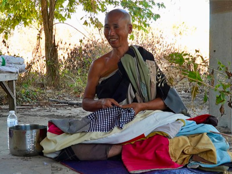 Vietnamese monk Thich Minh Tue prepares to take a nap in Thailand, during his  walk to India, Jan. 1, 2025.