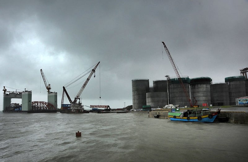 In this June 1, 2012 photo, oil tanks are under construction at a site operated by China National Petroleum Corporation at an offshore block of Madae Island near Kyauk Phyu, Rakhine State, Myanmar. Credit: Lwin Ko Taik/AFP