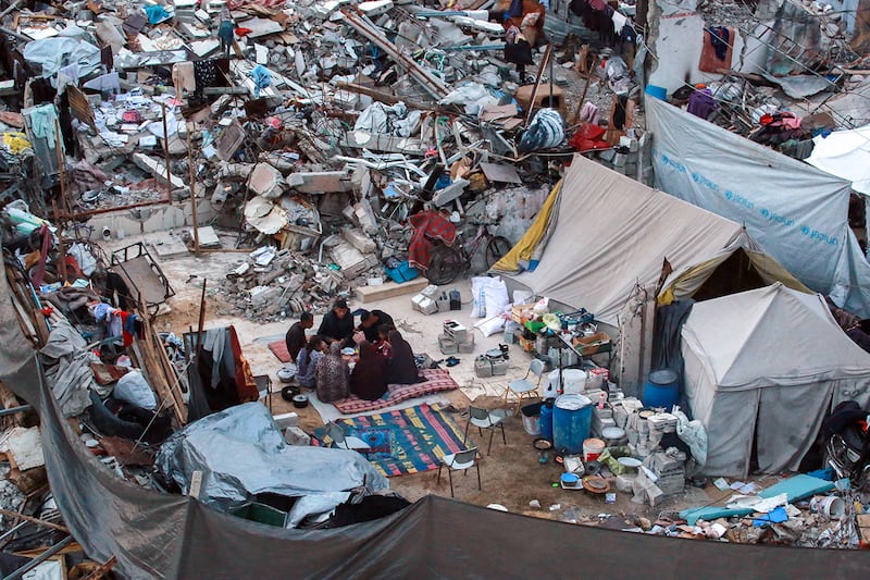 Doctor Khaled Mohammed Abu Jari, 57, center left, head of the critical care department at the Beit Hanoun Hospital has his fast-breaking iftar meal with his family outside their tent in Beit Lahia in the northern Gaza Strip during the Muslim holy fasting month of Ramadan.