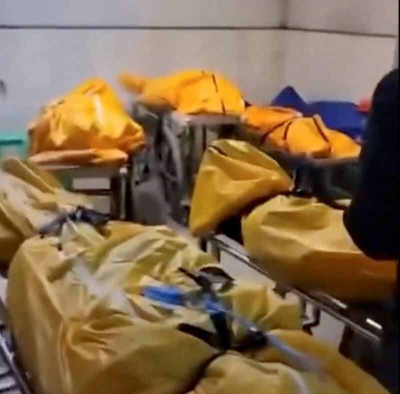 Several body bags are lined up around the level at a loading bay in a building in Chongqing, China, in this image released Thursday, Dec. 22, 2022. Credit: Reuters screenshot from video