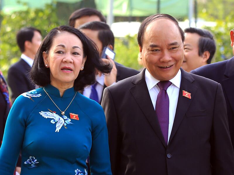 Vietnamese Communist Party Central Committee's Mass Mobilization Chief Truong Thi Mai, left, and Prime Minister Nguyen Xuan Phuc walk to a session of the 14th National Assembly in Hanoi, Vietnam, July 20, 2016.