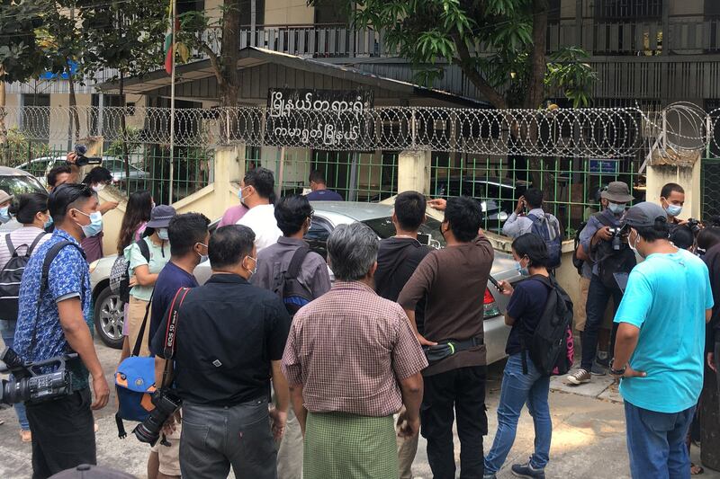 Members of the media gather outside Kamaryut Court in Yangon during a hearing in the case of Associated Press photographer Thein Zaw, who was arrested as he covered a demonstration against the military coup, March 12, 2021. AFP