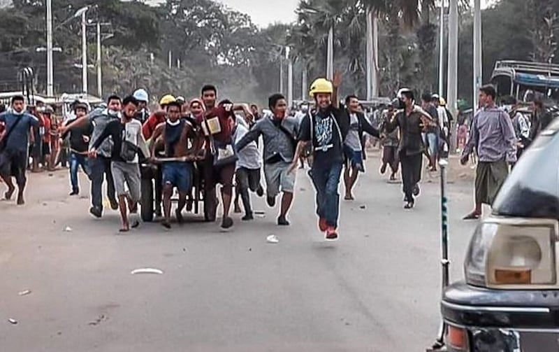 Volunteers and medics carry a fatally injured man who was shot when riot police fired on protesters at a government shipyard in Mandalay, Feb. 20, 2021. Credit: Citizen journalist.