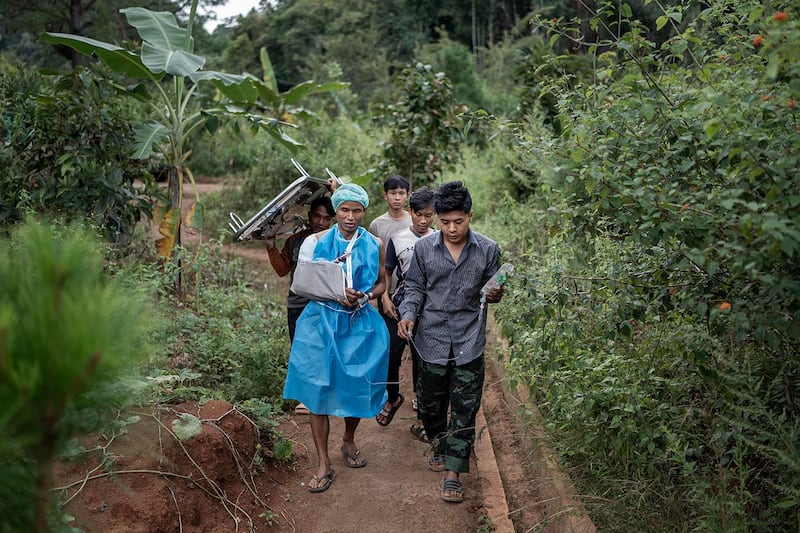 A patient walks to the recovery ward after minor surgery at O-1 hospital in Demoso, Kayah state, Myanmar, Nov. 5, 2024.