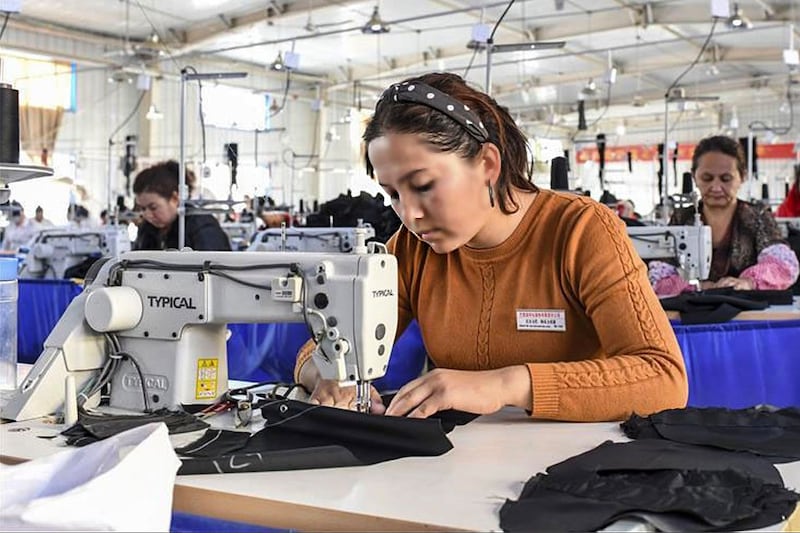 Uyghur workers sew clothing at a garment factory in Maralbeshi county, northwestern China's Xinjiang Uyghur Autonomous Region, in 2018.