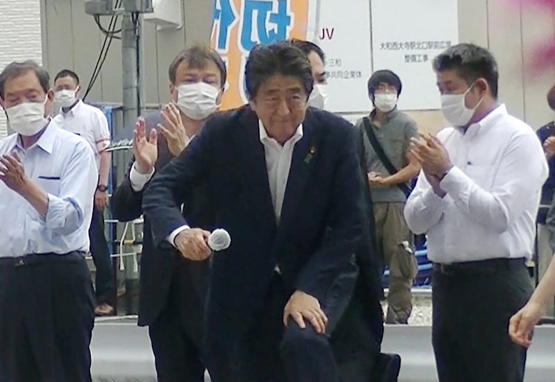 This image taken from video provided by witness Toshiharu Otani and released via Jiji Press shows former Japanese prime minister Shinzo Abe (C) attending an election campaign before giving a speech at Kintetsu Yamato-Saidaiji station square in Nara, while a man (2nd R-behind) suspected of shooting Abe shortly after stands in the background. Photo: Jiji via AFP