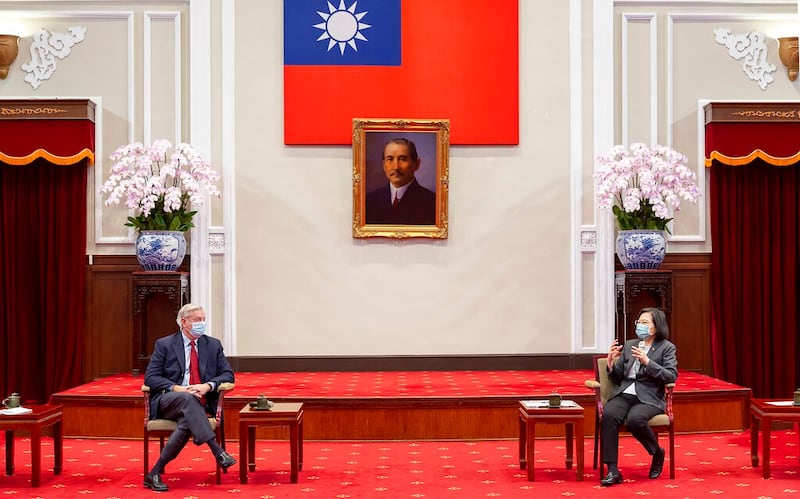 Taiwan's President Tsai Ing-wen (R) speaks with Sen. Lindsey Graham at the Presidential Office in Taipei, Taiwan, April 15, 2022, during a visit by U.S. lawmakers. Credit: Taiwan Presidential Office via AP