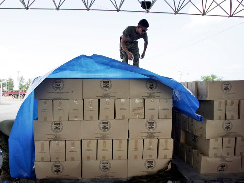 A U.S. Marine secures USAID supplies bound for cyclone devastated Myanmar at Utapao Air Force base, Rayong, Thailand, May 14, 2008.