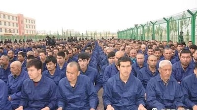 A photo posted to the WeChat account of the Xinjiang Judicial Administration shows Uyghur detainees listening to a 'de-radicalization' speech at a re-education camp in Hotan prefecture's Lop county, April 2017.