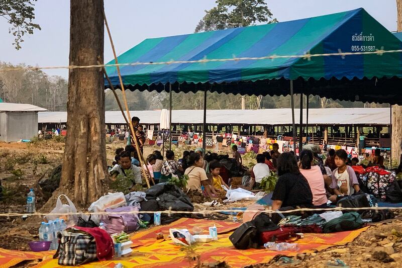 People fleeing fighting between the Myanmar military and opposition forces shelter on the Thai side of the Moei river, in Mae Sot district on April 7, 2023.