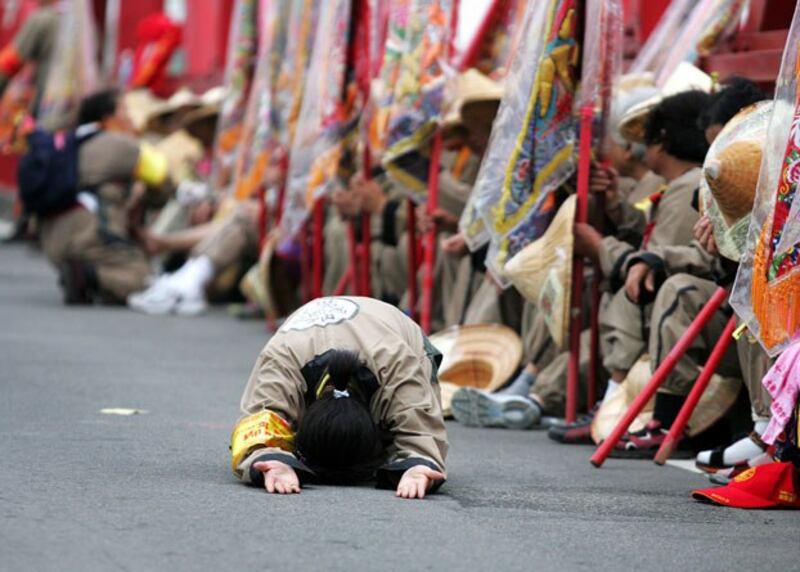 A woman prostrates herself during the annual pilgrimage to honor the sea goddess Matsu in Taiwan's Yunlin county in 2005. (Richard Chung/Reuters)