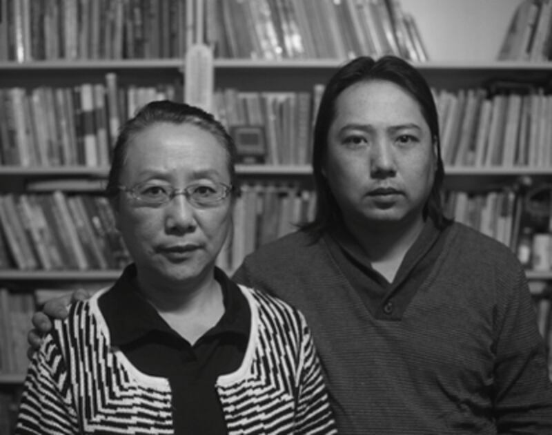 Xinna and Uiles under virtual house arrest, at their home, March 2014. (SMHRIC photo) 