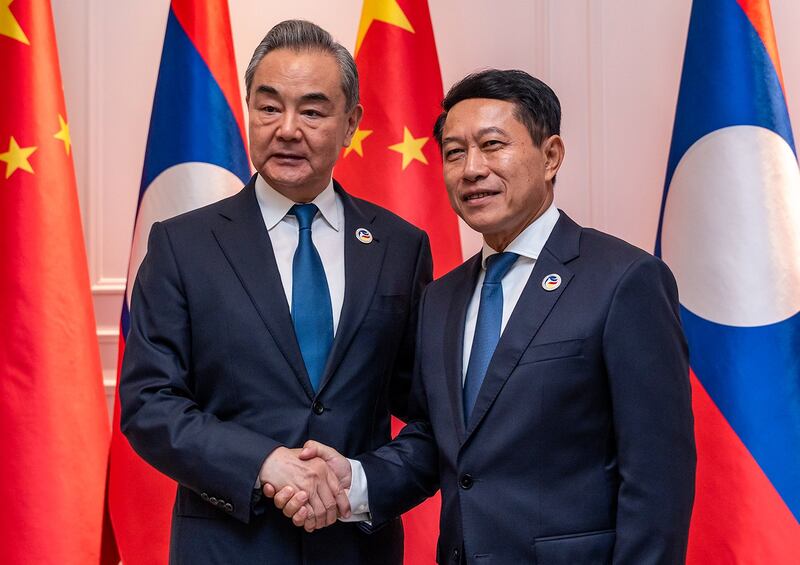 Chinese Foreign Minister Wang Yi, left, meets with Laos Foreign Minister Saleumxay Kommasith in Vientiane, July 25, 2024. (Kaikeo Saiyasane/Xinhua via Getty Images)