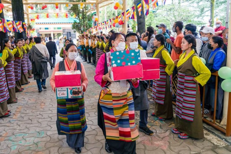 Exile Tibetans in traditional attire carry cakes to mark the 87th birthday of the Dalai Lama at the Tsuglakhang temple in Dharmsala, India, July 6, 2022. (Ashwini Bhatia/AP)