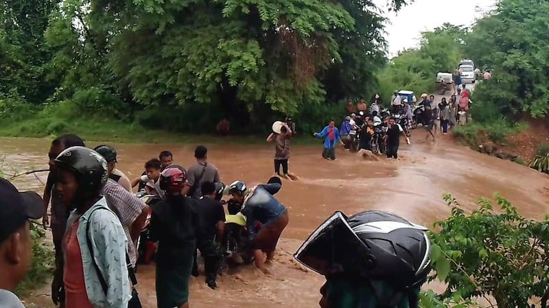 Displaced people from Kani township, Sagaing region, make their way across a stream, March 14, 2023. (Pyae Aung Naing – Kani)