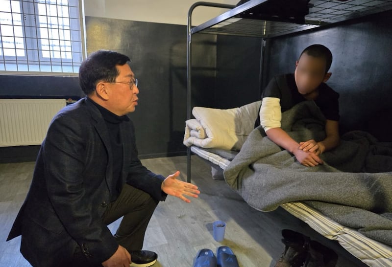 A North Korean soldier, right, identified as Ri, captured in Kursk and now at an unidentified detention center in Ukraine. Part of the image has been blurred by South Korean lawmaker Yu Yong-weon, left, who interviewed the soldier.