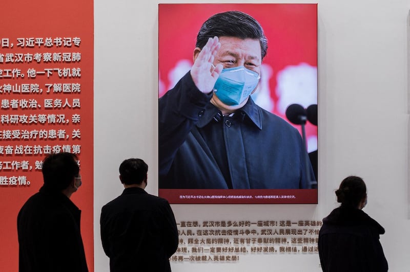 China's President Xi Jinping with a face mask shown in an exhibition about China's fight against the COVID-19 coronavirus at a convention center that was previously used as a makeshift hospital for patients in Wuhan, Jan. 15, 2021. Credit: AFP